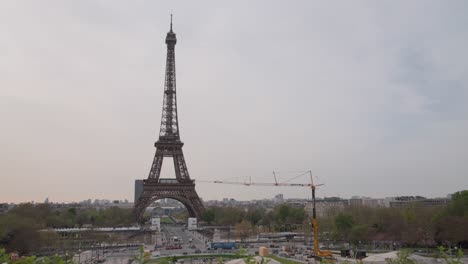 On-the-eve-of-the-Paris-Olympics,-construction-is-underway-in-Paris,-with-a-crane-in-front-of-the-Eiffel-Tower