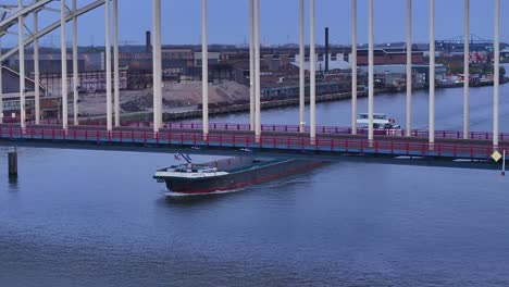 Aerial-View-Of-Vessel-Xanthos-Sailing-Across-The-River-In-Alblasserdam,-Netherlands---Drone-Shot