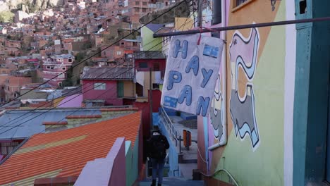 Woman-walks-down-La-Paz-Bolivia-street-alley-past-sign-for-fresh-bread