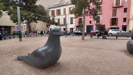 Plaza-Porta-Santa-Catalina-Palma,-Spain,-a-quiet-square-dedicated-to-art,-with-traditional-architecture-and-people