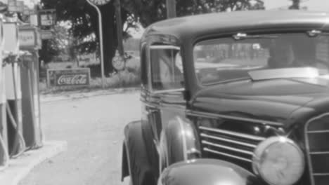 Woman-Drives-a-Classic-Car-After-Getting-Gas-at-the-Station-at-Daytime-in-1930s