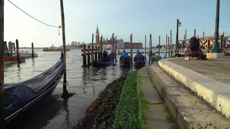 Venetian-Gondolier-Oarsmen-Climbs-into-His-Gondola-to-Prepare-it