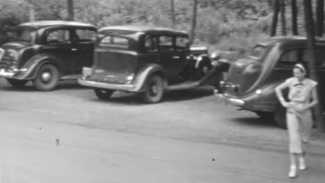 Man-and-Woman-Park-their-Classic-Car-Under-the-Shade-of-Trees-on-a-Summers-Day