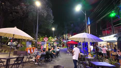 Lively-El-Poblado-nightlife-scene-with-open-cafes-and-neon-lights,-Medellin-Colombia