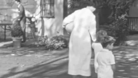 Uniformed-Nannies-Care-for-Children-Playing-in-the-Garden-of-a-Home-in-1930s