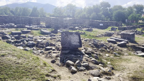 Moving-shot-of-an-old-Dacian-Tablet,-inside-the-Sarmizegetusa-archeological-site,-dating-the-Roman-empire-era