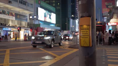 Closeup-shot-of-a-poster-showing-'aids-for-visually-impaired-persons'-with-blurred-view-of-vehicles-passing-at-background-in-Mong-Kok-district-in-Hong-Kong
