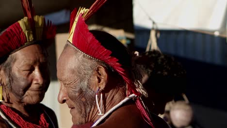 Close-up-shot-of-older-native-amazon-men-wearing-headdresses-with-colorful-plumes