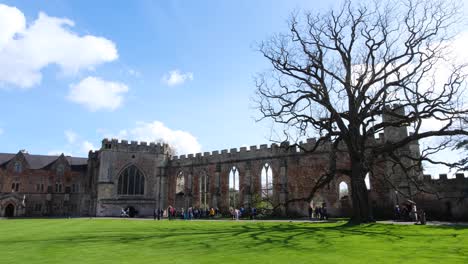 Visitantes-Caminando-Por-El-Césped-Y-Los-Terrenos-Dentro-Del-Palacio-Episcopal-En-La-Ciudad-De-Wells,-Somerset,-Inglaterra