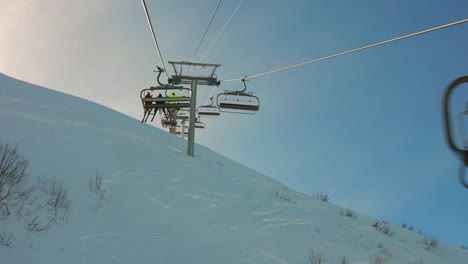 Chairlifts-ascending-snowy-slope-in-Flaine,-France-at-sunset