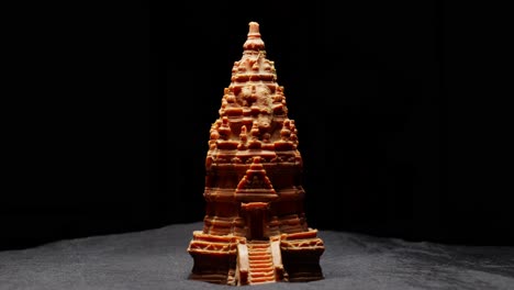 Borobudur-miniature-temple-emerges-from-darkness,-revealing-its-beauty