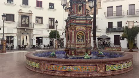 Der-Pescaito-Brunnen-Auf-Der-Plaza-De-España,-Dem-Geschäftigen-Zentrum-Von-Vejer-De-La-Frontera-In-Cádiz,-Andalusien,-Spanien,-Erfüllt-Die-Gegend-Mit-Einer-Ansteckenden-Energie,-Die-An-Einen-Lebhaften-Vergnügungspark-Erinnert