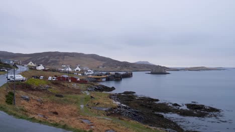 Scenic-landscape-of-coastal-road-in-remote-Castlebay-village-on-the-island-of-Barra-in-the-Outer-Hebrides,-Scotland-UK