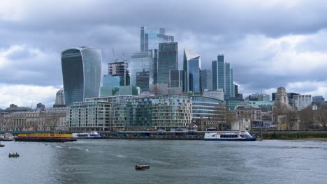 City-Of-London-Skyline,-Skyscrapers-filmed-from-the-Queen's-Walk,-Potters-Fields-Park-In-London,-England---March-2024