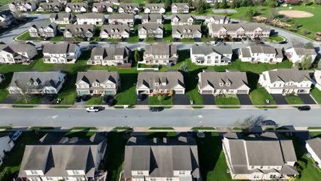 Lateral-drone-shot-of-homes-and-similar-modern-buildings-in-upscale-suburb-neighborhood-in-USA