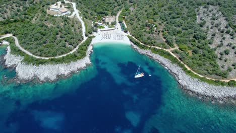 Aerial-of-Idylic-Ammoussa-Beach-Bay,-Sailing-Boat,-Lefkada,-Greece