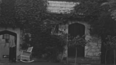 Rocking-Chair-in-the-Garden-of-a-House-with-Creeper-Plants-on-the-Walls