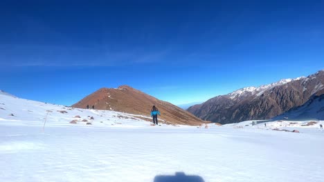 Hiker-with-backpack-climbing-top-of-mountain,-mountaineering-concept