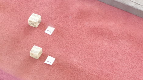 Two-dices-inside-a-museum,-replica-of-an-old-dice-used-by-the-Dacians-and-Romans-in-the-first-century