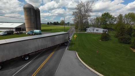 Industrial-truck-leaving-farm-in-american-suburb-during-spring-day