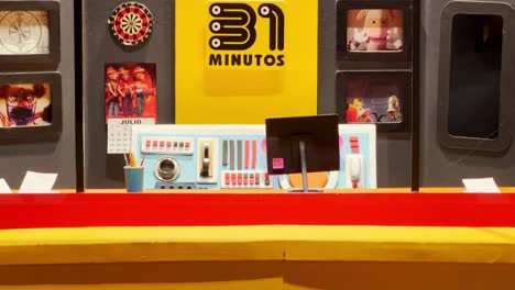 Model-of-the-31-Minutes-museum,-a-Chilean-comedy-television-series-sensation,-logo-design,-and-photos-displayed