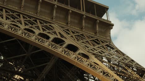 Handheld-pan-tracking-detail-shot-of-The-Eiffel-Tower-Tour-Eiffel-in-Paris,-France,-Europe