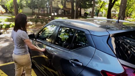 Middle-Aged-Woman-Moves-to-Driver's-Seat,-Hand-on-Door,-Slow-Motion