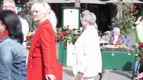 Elderly-woman-with-rose-attending-May-Day-parade