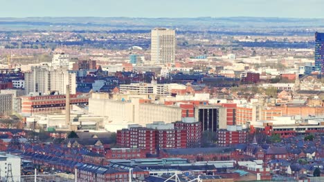 Sunshine-comes-from-the-clouds-and-illuminates-the-buildings-and-offices-of-Leicester,-UK-in-the-foreground-and-in-the-middle-of-the-shot