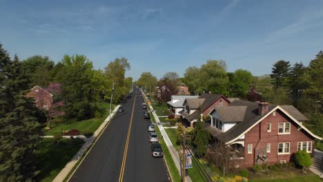 Fpv-flight-over-Main-Street-of-small-American-town-during-spring