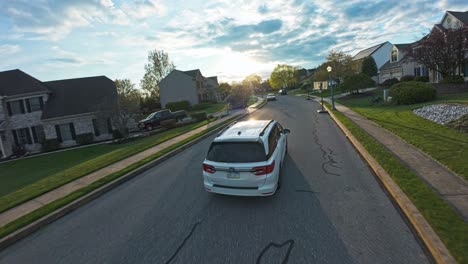White-Car-turning-into-street-of-suburb-residential-area-at-golden-hour