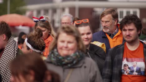 White-Dutch-crowd-walking-and-passing-by-during-Koningsdag-King's-day-festival