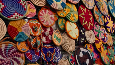 Seating-pads-in-traditional-Nubian-ornaments-placed-on-the-wall-of-the-shop-in-the-market-street-in-Nubian-village,-Aswan,-Egypt