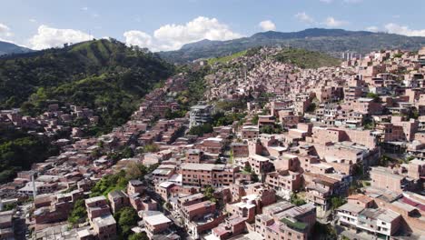 Comuna-13-favela-with-Metrocable,-Medellin-Colombia---aerial-flyover