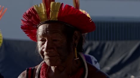 An-older-amazon-warrior-in-traditional-tribal-headdress,-carriyng-his-bow-and-arrows