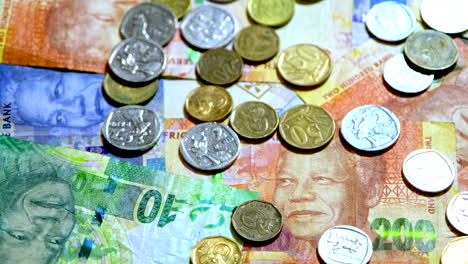 Detailed-close-up-view-of-South-African-coins-and-banknotes,-face-of-Mandela