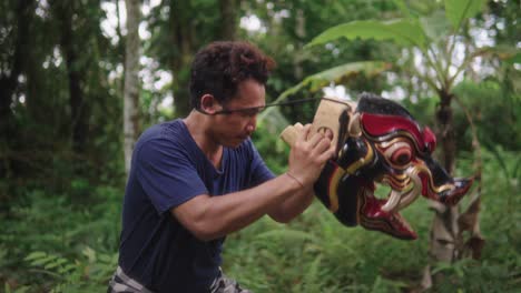 a-Balinese-artist-moves-the-mask-with-grace-and-beauty,-creating-mystical-movements-full-of-harmony