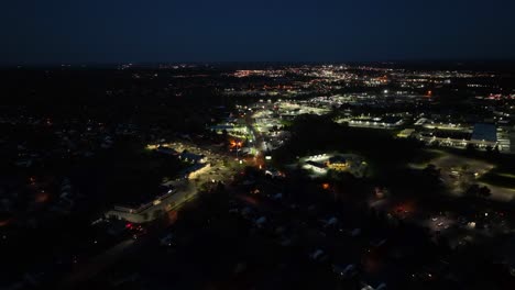 Luftflug-über-Beleuchtete-Amerikanische-Stadt-Bei-Nacht-Mit-Verkehr-Auf-Der-Straße