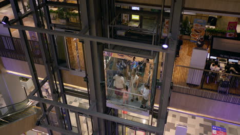 View-from-the-top-showing-an-elevator-with-passengers-in-it-while-more-people-coming-in