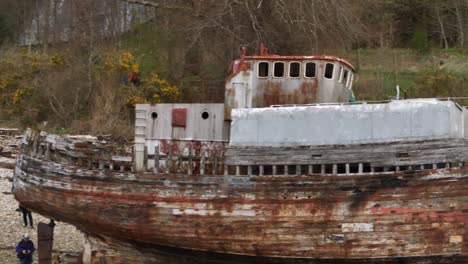 Aerial-panning-shot-of-the-rusted-remains-of-the-Corpach-Shipwreck