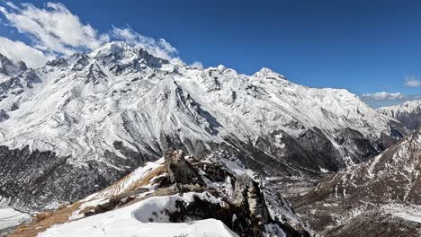 Inspiring-views-of-ice-coated-mountains-against-the-clear-blue-sky,-with-a-rugged-ridge-of-Kyanjin-Ri-guiding-the-eye-into-the-vast-valley-below