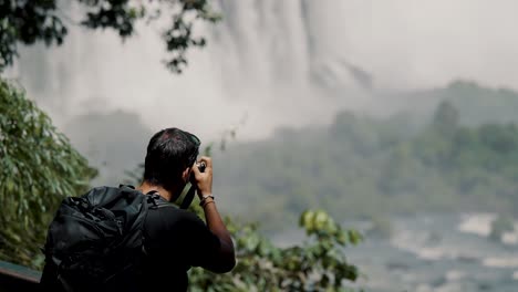 Male-Tourist-Taking-Photos-And-Videos-At-Iguazu-Falls-In-Argentina---Medium-Shot