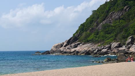 Stunning-sand-beach-with-green-cliffs-on-summer-day