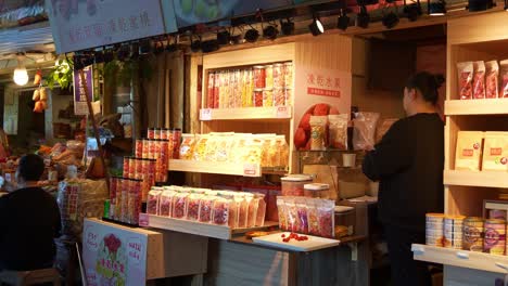 A-stall-selling-freeze-dried-fruits-amidst-the-charming-old-streets-of-Jiufen,-a-picturesque-mountain-village-in-the-Ruifang-district,-New-Taipei-City,-a-popular-tourist-attraction-of-Taiwan