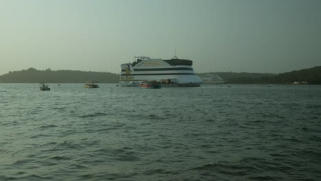 Cruise-ship-anchored-in-calm-waters-with-boats-in-the-surrounding-in-India