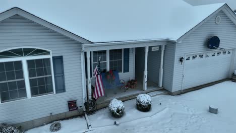 American-flag-on-snow-covered-rancher-home