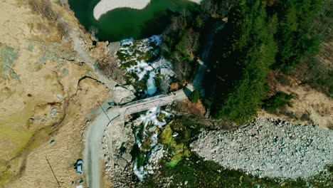 Vista-Aérea-Circular-Sobre-Una-Pequeña-Cascada-Que-Desemboca-En-Una-Piscina-En-Noruega