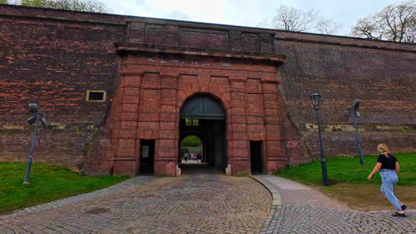 People-In-Historical-Landmark-With-Brick-Gate-in-Vysehrad,-Prague,-Czech-Republic