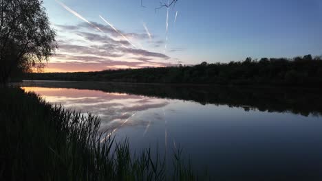 Scenic-Fish-Pond-at-Sunrise:-Tranquil-Waters-and-Lush-Vegetation