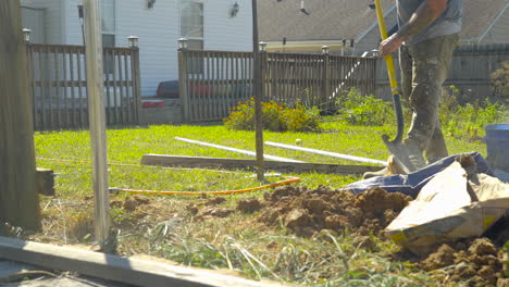 Man-mixing-concrete-on-hot-summer-afternoon,-static-shot